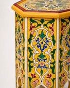 Top-down view of an octagonal wooden side table showcasing a symmetrical hand-painted mandala pattern.